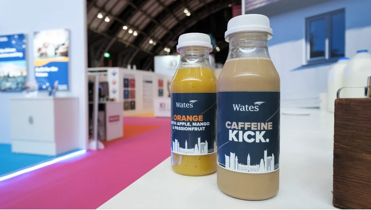 Two bottles of juice and smoothies at a large exhibition