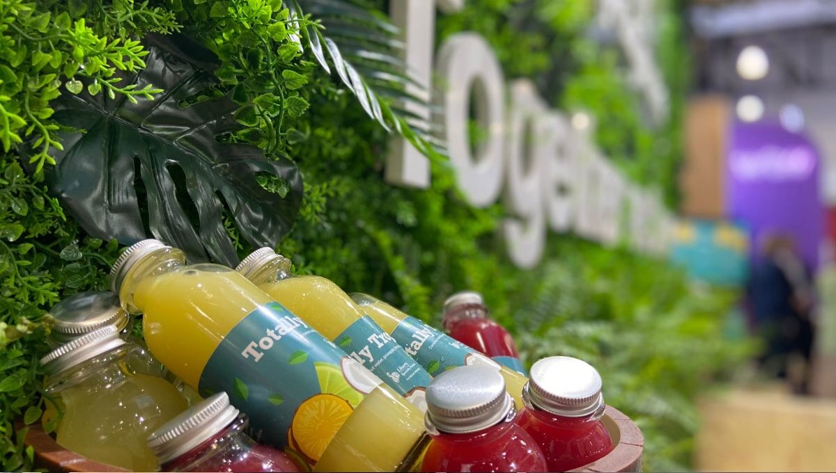 Several glass bottles of juice in a container